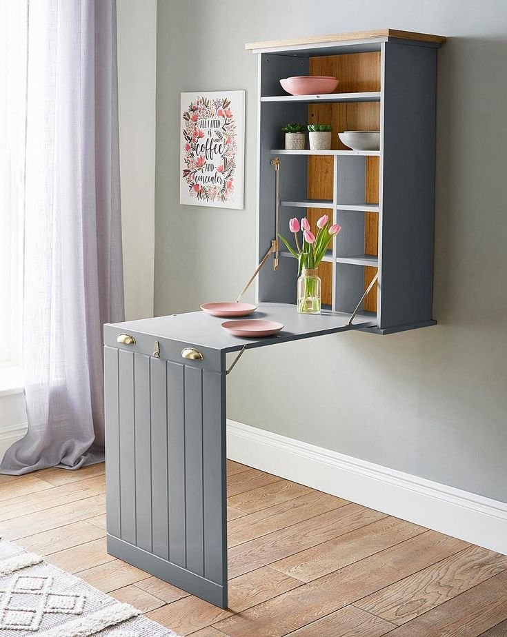 "A foldable desk in a kids' room, providing a study area that can be easily stored when not in use.